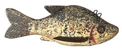 K49 Hand carved Folk Art Fish Decoy featuring original white, black and red painted and decorated surface with carved details for mouth and gills. Solid wooden body with stationery tin fins with painted details to match the body, tack eyes and a metal weight embedded into the underbelly. Approximate measurements: 6 ½ long x 2 ¼ wide x 2 ½ tall  