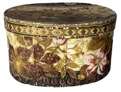 K254 Dated and identified 19th century Pennsylvania oval wallpaper box signed Laura Krauss 1832 in pencil on the bottom.  The box is paperboard, hand stitched construction and is covered in a floral wallpaper in rich earth tones. Nice condition. Measurements:  8 ¼ long x 6 ½ wide x 4 3/8 tall. 