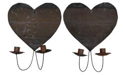 *SOLD* J302 Absolutely fantastic pair of late 19th century � early 20th century Folk Art Heart shaped double arm tin wall sconces. Each of the delicate arms supports a candle socket / drip cup with punched edges bearing remnants of the original bittersweet red paint. Hearts retain their original surface patina and pitting indicative of age. A small sticker from a prior Southeby�s sale remains intact on the back of each heart. Each heart measures 10 ½� wide x 9 ½� tall. Overall height is 13� tall. Cups extend approximately 5 ½� from the wall. 