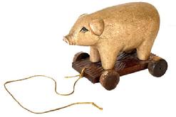 L134 Folk Art carved wooden Pig Pull Toy. Solid wooden carved pig features painted and textured surface replicating skin with detailed carved ears, mouth, snout and very expressive eyes. It is mounted on a wooden base with carved textured details. The wooden wheels move freely. Missing its tail and has one mix-matched wheel otherwise in great condition. Approximate Measurements: 8 ½ long x 4 5/8 wide x 5 ¾ tall.