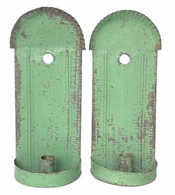 RM1291 Pair of Hanging tin wall sconces, each with crimped round/arched top edge, embossed reeded columns, finely folded edges, a drilled hole for hanging and a demilune dish holding a single rolled edge candle socket that is 1 1/2� tall. Solder joints are secure. Sconces retain old apple green paint. Measurements: 11 3/4� tall x 5� wide x 2 1/2� deep