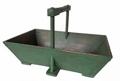 RM1415 Rectangular solid wooden carrier with deeply canted sides and tall, unusual applied sturdy handle in original green painted surface. Great wear and natural patina inside from years of use. Carrier has applied �shoe� feet.  Measurements: 18" long x 11 3/4" wide x 11" tall (at handle). The sides are 5 1/8" tall