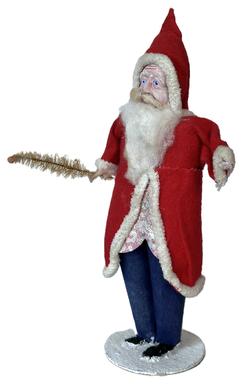 **SOLD** K1884 Santa with long cottony beard and mustache wearing blue trousers with a red hat and long coat with a metallic print front and white furry trim. He is holding small feather tree in his right hand.  Bottom is stamped but illegible. Santa is approximately 9" tall on a 2 3/4" diameter base.  