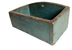 **Sold**RM1442 New England original blue painted wallbox. Slightly rounded back with hole for hanging and tapered sides. Circa 1830's-1860's. Excellent wear from years of use. Cut nail construction. Measurements: 11 7/8" wide x 6 3/8" deep x 5 1/2" tall in back. The front is 4" tall.  