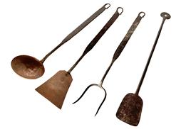 J208 Group of four early hand forged iron kitchen utensils. The fork, spatula and ladle are all marked on the back side of the handle and have matching iron curly-cue ends. The bowl of the ladle and flared end of spatula are made of hammered copper. The iron peel/spatula has a flat end with a hole for hanging. All four items measure approximately 16" long.