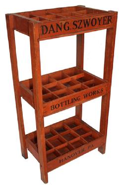 D163 Early 20th century bottle rack with great original bittersweet paint with black lettering. This rack was used in a store to sell ginger ale for Dang Szwoyer, Hanover PA. Circa 1920 -1930. Measurements: 19" wide x 12" deep x 36" tall