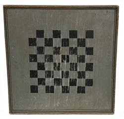 K76 19th century Pennsylvania Checkers Game Board retaining its original black painted playing field against an original pewter gray background. Constructed from a single wide pine plank surrounded with applied wooden molded edge. The back of the board retains its untouched old natural surface. Great wear from years of use. Very sturdy. Measurements: 20 ½ square x 2 thick. 