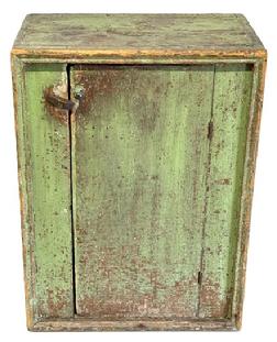 M1182 Early 19th century original apple green painted pine one door cupboard with picture frame molding surrounding front. One board, square head nail construction with evidence of pith saw marks on back. Clean interior with shelving for added storage. The wood is white pine. Circa 1800-1820s. Measurements: 22 &frac12;� wide x 14 &frac34;� deep x 30� tall. 