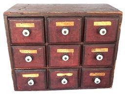 L359 19th century Pennsylvania nine-drawer spice chest / apothecary bearing original red painted surface with molded edged drawers bearing original porcelain knobs and original paper labels. Tiny square head nail construction. The wood is pine . Circa 1840-1850�s. Measurements: 14� wide x 7� deep x 11� tall.   