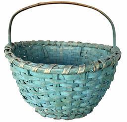 H379 Early 20th century Ohio painted basket. Woven splint with steamed and bent bentwood handle and original blue paint. The rim of the Basket is single wrapped, the Basket is resting on an applied base with a reinforced bottom