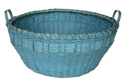 J37 19th century New England original blue painted round utility basket with attached steamed and bent side handles. Tightly woven with single wrapped rim with bumped up bottom inside the basket for added air flow. Great condition. Circa 1880s. Top diameter (slightly out of round) is 12 ½ x 13" diameter. Sides are 5 ¼ tall. Bottom measures 9 ½ diameter.