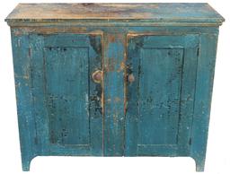 W363Early 19th century two door Storage Cupboard witth old blue paint over the original dark blue, very unusual, sides are mortised through the top of the cupboards, nice high cut out foot, two paneded doors  mortised and pegged, the interior of the cupboard has it original paint, the back board are held in place with square head nail, showing pit sawed marks. circa 1820 Measurements are:48" wide x 18" deep x 41" tall