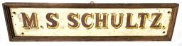 F287 Early 19th century Pennsylvania trade sign with �M. S. Schultz,� hand painted in red letters with yellow and black shadowing on a white painted background. The sign is single sided with a nice applied molded edge. The wood is pine.  Measurements: 25� wide x 5 ¾� tall x 1 ½� thick. 