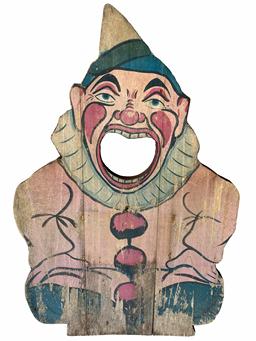 G388 Early 20th century  wooden  tossing game. The face of a Clown lithographed on the wood panel with hole in his mouth. Try to throw a ball in his mouth to determine your score. Measurements: 15 3/4" wide x 24 1/4" tall x 3/4" thick