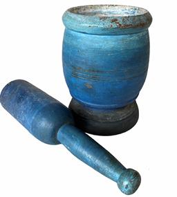 G526 Mid 19th Century beautifully blue painted wooden mortar and pestle from New England.  Each piece was made from a single piece of wood and both have remnants of three matching incised rings indicative of them being a matched pair from inception. Both pieces are very solid, with only a few minor surface splits in the wood at base of mortar�s bowl and a small nick on the very bottom edge of the base from an apparent wayward saw cut that shows along the very bottom of the mortar. Mortar measurements are: 6 1/4� tall x 4 1/2� diameter base. Pestle measurements are: 9 1/4� long x 2 1/4� diameter bottom with  a 1� ball at top. 