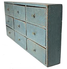 *SOLD* J361 Unique 19th century Pennsylvania nine drawer apothecary in original old blue painted surface with small brass pulls. Dovetailed case with mortised drawer stretchers. Drawers are square head nail construction. Very shallow depth. Measurements: 25 ½� wide x 3� deep x 11 3/8� tall.