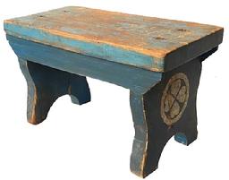 K4 Late 19th century Pennsylvania original blue painted stool with remnants of BARBARA hand painted in original yellow across the top and remnants of original white painted medallion decorations on each end. One end features a six-petal floral motif, and the opposite end features a four-heart clover motif.  The stool boasts shaped ends with half-moon cut out feet and a drop apron on each side that is mortised through the legs. The wood is pine. Measurements: 13 wide x 7 deep x 7 ¾ tall. The top and legs are a full 1 thick. 