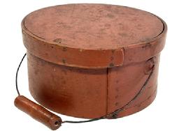 M1120 19th century New England bail handle Pantry Box in the original red paint with wire bail-handle with turned wood grip. The overlapping steamed and bentwood sides are secured by small tacks. Natural patina interior. Measurements: 9 5/8� top diameter x 9 &frac14;� bottom diameter x 4 &frac34;� tall. 