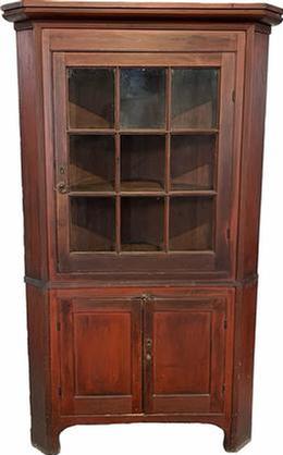 H262  Berk�s County, Pennsylvania original red painted two-piece nine window lite corner cupboard with two blind-panel doors on bottom. Reeded molding throughout. Nice painted surface, never over painted. High cut out foot. Original wavy glass in top door. Interior retains an original red-wash surface. Circa 1820 � 1850. Measurements: 78 &frac12;� tall and takes a 31 &frac12;� corner  