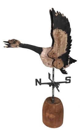 H342 Early 20th century New England  paint decorated wooden Canada Goose Weathervane. Great piece of American folk art. The goose is constructed of layered wood panels and mounted on a metal directional and solid round wooden base for display purposes. Measurements: 35 ¾� tall x 23 ¼� long. The base is 7� diameter.