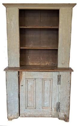H408 18th century Country Stepback Cupboard original gray paint on the exterior and a dark red interior, circa 1780-1790 . The cupboard is One piece ,with open top and double paneled door in bottom with "H" hinges. Cut out feet, bead board back. Rose head and tee nail construction. The wood is pine, Cleaned down to the original gray with old dark ed paint on the inside.