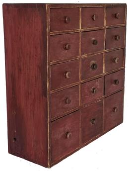 J110 Early 19th century New England Apothecary featuring a dovetailed case and 15 dovetailed drawers retaining the original dry, red painted surface. Square head nail construction. Drawers retain original wooden knobs/drawer pulls