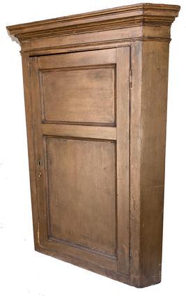 F503 18th century Hanover, Pennslyvania hanging Corner Cupboard, with the original nutmeg paint, with a two panel full mortised door, with tall applied molding, the wood is white pine, the back boards are held in place with rose head nails