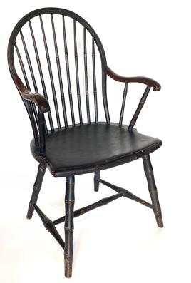 G369 19th Century black painted continuous arm Windsor Chair. Very sturdy with nine spindle back, curved arms, shaped seat and bamboo style turnings with H stretcher base.  Circa 1810. Measurements: 22 1/2� wide (across arms) x 16� deep (seat) x 37 1/2� tall (back). The seat is 17� from floor.