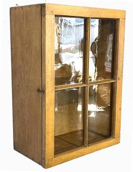 H951 Stunning 19th century Ohio hanging glass door cupboard with the original yellow paint on exterior and interior. Fully mortised and pegged door with four windowlites, all square head nail construction. Beautiful back boards. Circa 1840.  Measurements: 20" wide x 11" deep x 28" tall.