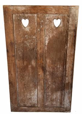 H85 Mid 19th century raised panel Door with hearts cut out, from a wall unit, retains old dark surface on one side and the remnants of white wash on the other side. All mortised & pinned, circa 1850.