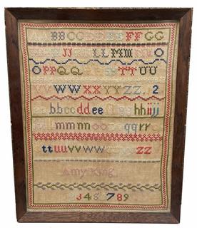 G572 Sampler identified as being wrought by �Amy King�, undated. This simplistic work includes two sets of double alphabets, one upper case and one lower case, spread over a total of seven stitched rows, along with the maker�s name, and the numbers 1 - 9, with each row being separated (and overall bordered) by bands of hand wrought geometrical shapes. The Sampler is linen and wool, and bears very minor losses throughout that are indicative of age. Colors remain vibrant throughout. Wooden frame contains minimal damage. Frame measures 17 3/8� tall x 14� wide. 