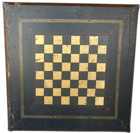 **SOLD** J39  Exceptional 19th century American folk art paint decorated gameboard / checkerboard boasting original gold, green and red paint on black background. The front edges are beveled up to ¾� from the corners- creating a unique design that is further enhanced by delicate geometrical and scrolled designs painted in each corner. The beveled edges are painted gold and red. One board construction. Nice wear. Measurements: 22 ¼� x 22 ½� x 7/8� thick