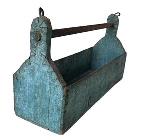 RM1553 New England wooden tool carrier retaining its beautiful original dry blue painted surface. Wear on handle and interior is indicative of heavy use. The top edge of each end is covered with metal to protect the wood. Circa 1880-1900. Measurements:  19 long x 6 ¼ deep x 10 ½ tall (ends) x 4 ¾ tall (sides).  