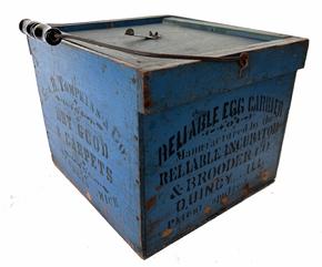 RM1348 Late 19th century Egg carrier with the original blue paint and black stenciled advertising. The following advertisements, � Geo B. Tompkins and Co Dry good and Carpet, Sturgis Mich. Reliable  Egg Carrier Brooder Co. Quincy Ill There is also a patent date  . Removable lid, The piece was made for a Country General Store. \Measurements are 12 1/2� xx 13 inches.