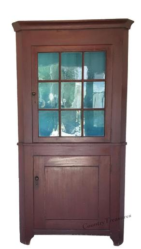 D335 Pennsylvania Softwood Two Part Corner Cupboard. Cove molded cornice, single nine pane glazed upper door above a single lower paneled door and cut out bracket feet. Old red paint.   83"h. x 43-1/2"w. x 22"d.