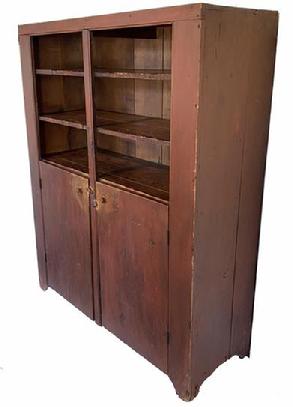 G787 Early 19th century Pennsylvania canning cupboard in old dry red paint. Open top with two batten doors below. Beaded edge around door/openings and nice cut out feet. All square head nail construction. Nice wear and patina indicative of age and use.