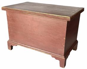 J159 Late 18th century Pennsylvania miniature blanket chest retaining old red painted surface and spectacular details such as applied reeded molding around the lid, a tightly dovetailed case and a beautiful, applied bracket base featuring cut out designs that repeat on all four corners. Clean, natural patina interior boasts a lidded till. "T" nail, square nail and dovetail construction. Measurements: 19 ½� wide x 11 ¾� deep x 13 3/8� tall