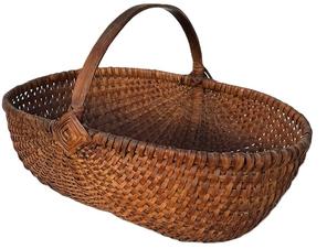 K1844 Oval shaped Melon Basket of ribbed and woven oak splint construction with natural finish boasting the "Eye of the Wind God" on each side of the handle. Tightly woven. Approximate Measurements: 15 ¼ long x 10 ¾ wide x 10 tall at handle. The sides are 5 ¼ tall. 