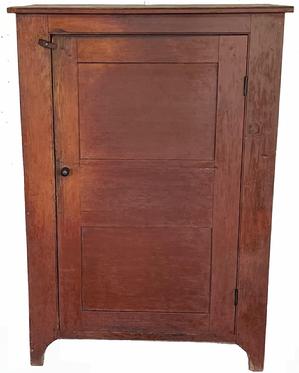 H997 Delightful late 18th Century Pennsylvania red painted one door cupboard boasting a double paneled door that is fully mortised and double pegged. The entire cupboard is �T� nail and wooden pegged construction. A beaded edge surrounds the door opening and also runs along the front of the top board. Clean, natural patina interior with three shelves � the top shelf bearing a plate groove along the back edge. Tall cut out feet. Nice wear. Circa 1790. Measurements: 40� wide x 20 ¾� deep x 57 ½� tall