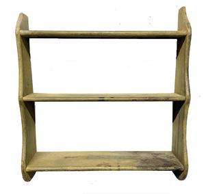MS4 19th century Pennsylvania hanging wall shelf with three shelves and shaped ends retaining its original sage green painted surface. The graduated shelves are mortised into the sides and bear rounded front edges. Small wire nail construction. The wood is pine. Circa 1850s. Measurements: 25 &frac12;� wide x 7� deep x 27 5/8� tall. Shelf depths from top to bottom are: 4 &frac34;�, 5 &frac34;� and 6 &frac34;� deep. 