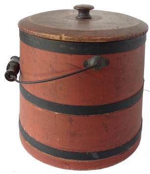 **SOLD** U315 Sugar Bucket with lid bearing original dry bittersweet painted surface with black painted metal bands securing the sides. Wooden knob on lid. Wire bail handle with wooden handle grip. Staved tongue and groove construction secured with metal bands. Natural patina interior. Untouched condition. Measurements:  11 1/4" diameter (bottom) x 9 1/4" diameter (top) x 9 3/4" tall. 