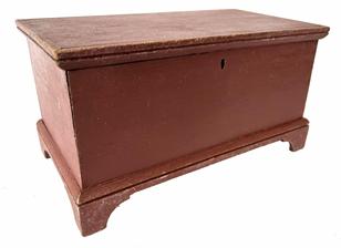 **SOLD** H488 � Mid 19th century Shenandoah Valley, Virginia diminutive walnut blanket chest with applied bracket base. One board, square-head nail construction retaining an old red painted surface. Applied molded edge around the top. Original hardware intact. Measurements: 10 ½� wide x 5 ¾� deep x 5 ½� tal