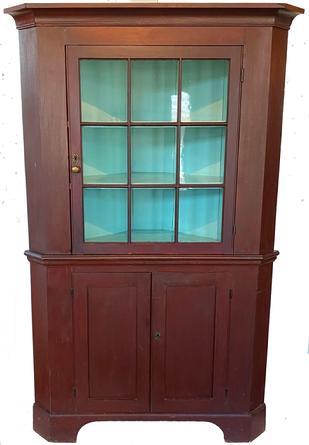 F580 Early 19th century Pennsylvania red Painted pine Two-Part Corner Cupboard. Cove molded cornice, single six pane glazed upper door above two sunken panel lower doors, nice high cut out bracket base. York County, PA circa 1820
