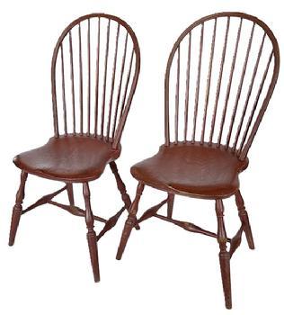 L12 Pair of early 19th century New England nine spindle bow back Windsor Chairs featuring beautiful saddle seats, bamboo turned spindles and legs with a center stretcher fastened to side runners with bold turnings in old red over original black paint. Circa 18001820. From a collection in Pennsylvania. Measurements: 20 ½ wide across front legs x 38 ½ tall (back). Seats are 17 wide x 17 deep x 17 ¼ tall.  