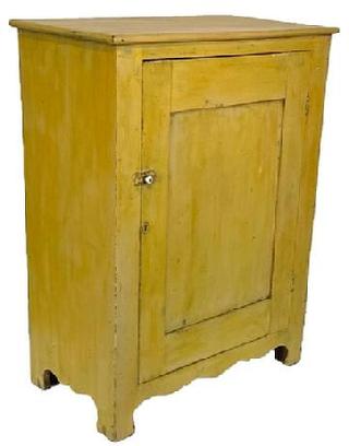 J15 Early 19th century Lancaster Co. Pennsylvania one door storage cupboard retaining its original yellow painted surface. The Cupboard has a single panel door which is  fully mortised,   solid ends with a nice high design cut out The front has a decorative cut out feet.  The back  board are held in place with Square head nail . Clean, natural interior. Measurements: 31 ¾ wide x 17 ½ deep x 42 ¼ tall