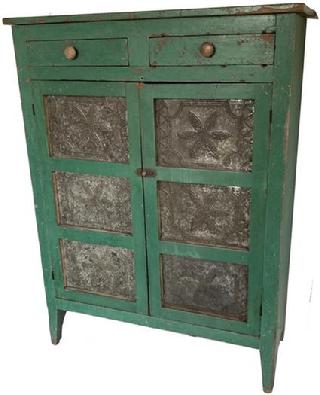G448 19th century Floyd County Virginia, Pie Safe,with early imerial green paint over the original red, Two doors that is mortised, with six hand punched tins, the pattern of the tins is a large six peddle flower, inside of a punched boarder. Two dovetailed drawers, one board ends, natural patina on the inside. circa 184