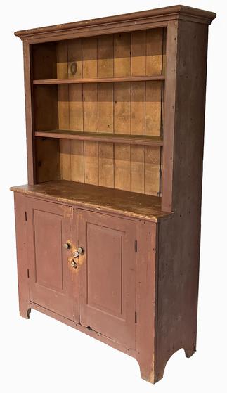 H95 Early 19th century Pennsylvania one piece open top stepback cupboard in dry, original red painted surface featuring open shelves over two beautiful, raised panel doors. Upper shelves boast double beaded edges along the front. The two fully mortised and pegged doors are raised panel inside and out and open to a clean, natural patina interior with shelf for added storage.  Applied molding around top. Half-moon cut outs on ends. Square head nail construction. Measurements: 49 ½� wide x 76� tall. It is 17 ¾� deep at waist and 13� deep at top molding.