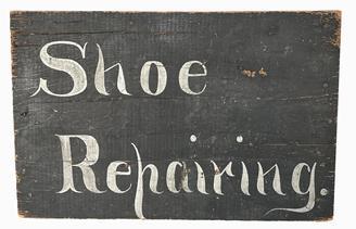 J218 Pennsylvania wooden Trade Sign advertising "Shoe Repairing". The hand painted lettering is done in silver paint on a dark blue background. Single sided. The support boards on the back side have acted as battens to keep the sign from warping/twisting over the years. Measurements: 17 ¼ wide x 11 ¼ tall.