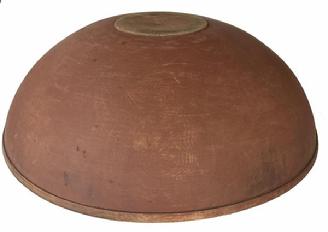 H466 - 19th Century Pennsylvania extraordinary wooden bowl in original salmon paint. Bowl boasts a chamfered interior lip with a distinct molded rim around the top outer edge and rests on an ever so slightly raised foot. Very heavy and sturdy. Measurements: 19 x 19 ¼ diameter x 6 ¼ deep. Raised foot area measures 5 x 5 1/8 diameter