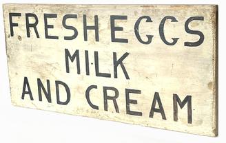 H941 Pennsylvania hand painted wooden Trade Sign advertising "Fresh Eggs  Milk  And Cream". Black painted lettering on a white background with beveled edges. Single sided. Measurements: 24 3/4" wide x 12" tall x 3/4" thick